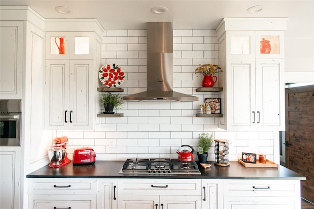 8138 Ranch Club Rd, Missoula, MT 59808 - kitchen featuring wall chimney exhaust hood, appliances with stainless steel finishes, dark countertops, and decorative backsplash