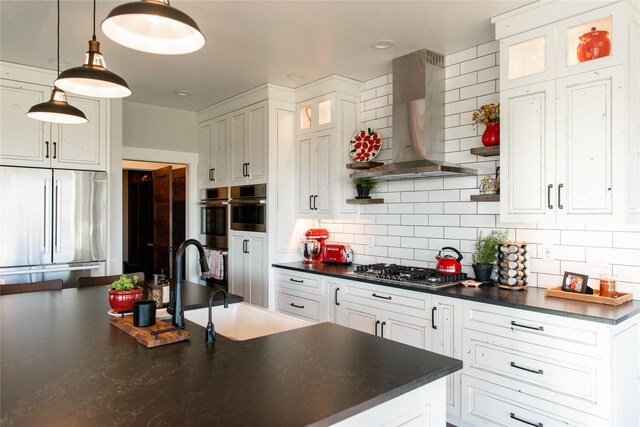 8138 Ranch Club Rd, Missoula, MT 59808 - kitchen with wall chimney range hood, appliances with stainless steel finishes, dark countertops, and backsplash