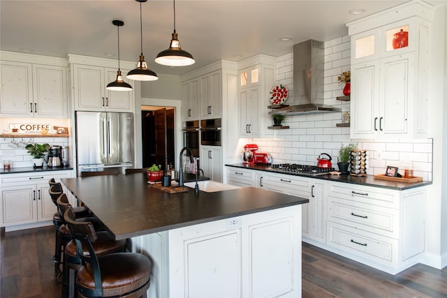 8138 Ranch Club Rd, Missoula, MT 59808 - kitchen featuring stainless steel appliances, dark countertops, a sink, wall chimney exhaust hood, and decorative backsplash