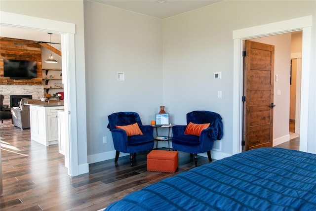 8138 Ranch Club Rd, Missoula, MT 59808 - bedroom with dark wood-type flooring, baseboards, and a stone fireplace