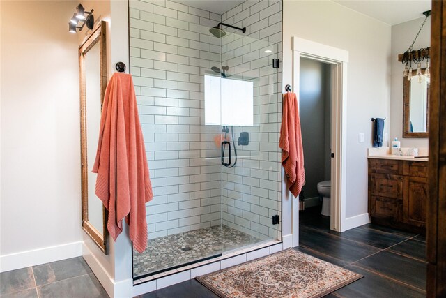 8138 Ranch Club Rd, Missoula, MT 59808 - bathroom with a shower stall, toilet, vanity, and baseboards