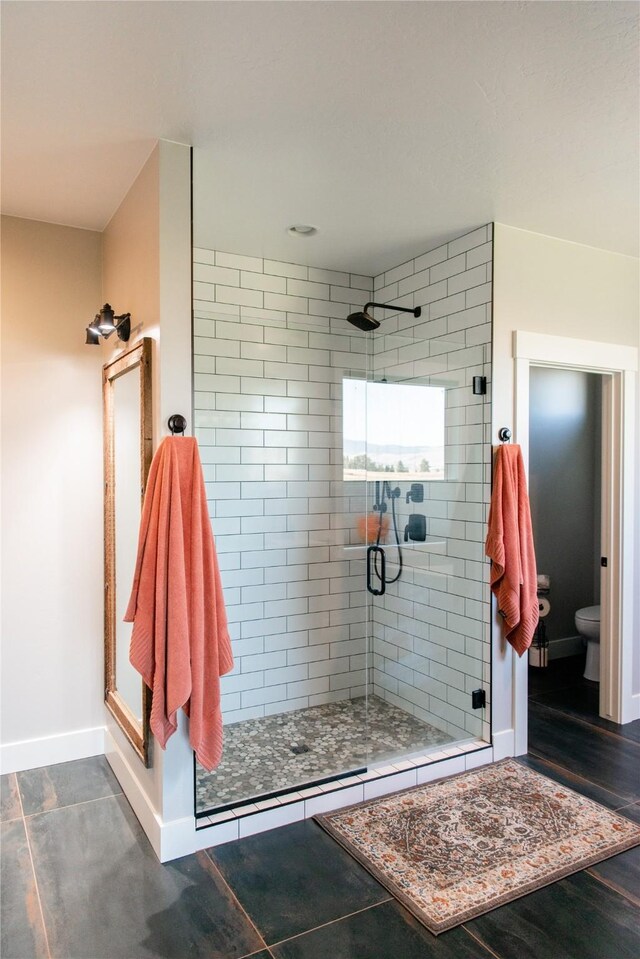 8138 Ranch Club Rd, Missoula, MT 59808 - bathroom with a stall shower, toilet, and baseboards