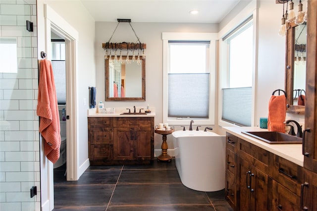 8138 Ranch Club Rd, Missoula, MT 59808 - bathroom featuring two vanities, a freestanding tub, a stall shower, recessed lighting, and baseboards
