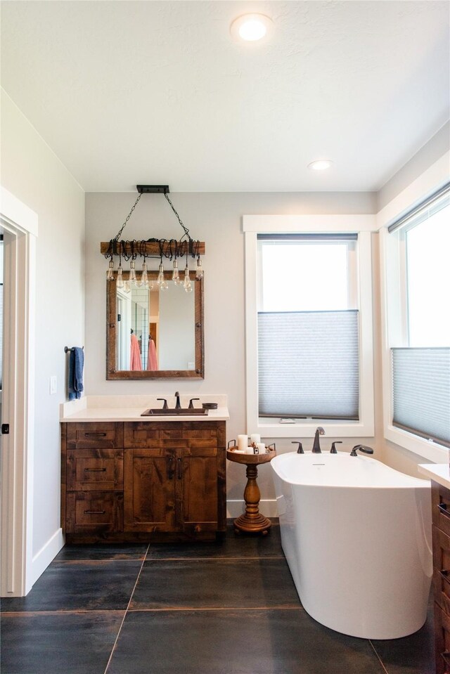 8138 Ranch Club Rd, Missoula, MT 59808 - full bathroom with vanity, a freestanding bath, wood finished floors, baseboards, and recessed lighting