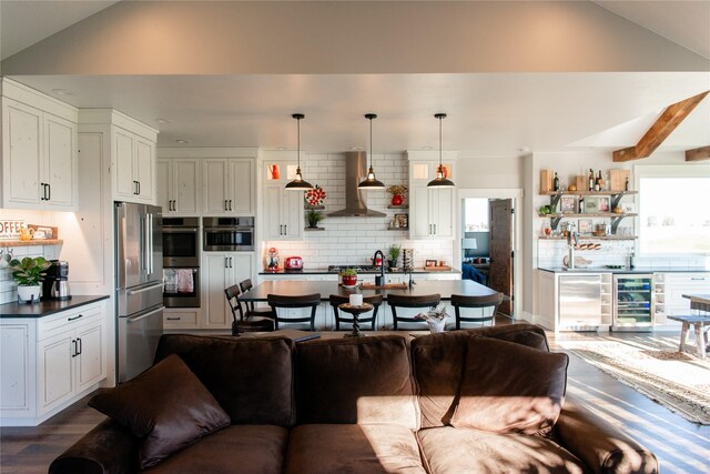 8138 Ranch Club Rd, Missoula, MT 59808 - living area featuring lofted ceiling, wood finished floors, and wine cooler