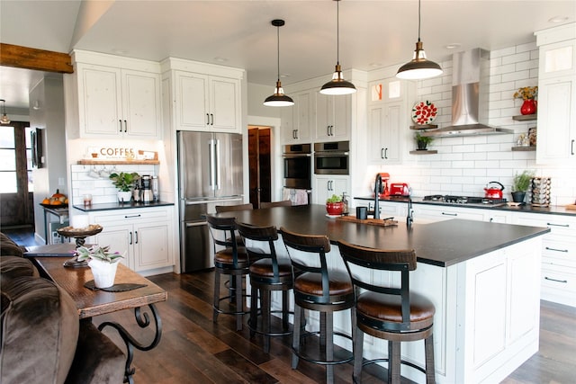 8138 Ranch Club Rd, Missoula, MT 59808 - kitchen with appliances with stainless steel finishes, wall chimney exhaust hood, dark countertops, tasteful backsplash, and recessed lighting