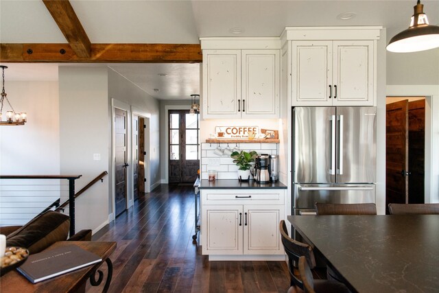 8138 Ranch Club Rd, Missoula, MT 59808 - kitchen featuring freestanding refrigerator, dark countertops, white cabinetry, dark wood finished floors, and beamed ceiling