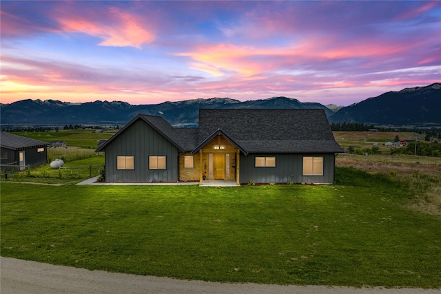 993 Lecoure Ln, Stevensville, MT 59870 - view of front facade featuring a mountain view, board and batten siding, and a front yard