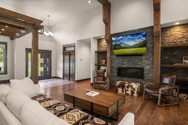 136 Turnberry Ter, Columbia Falls, MT 59912 - living area featuring wood finished floors, a stone fireplace, and high vaulted ceiling