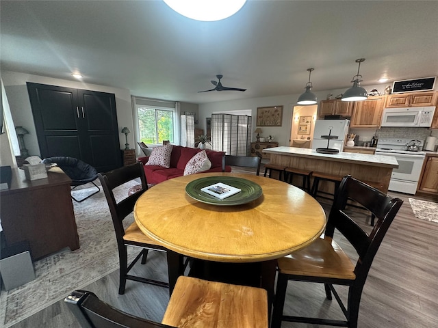 1265 Jellison Rd, Columbia Falls, MT 59912 - dining area with light wood-style flooring and a ceiling fan