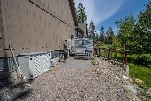 1265 Jellison Rd, Columbia Falls, MT 59912 - view of property exterior featuring a wooden deck and a cooling unit