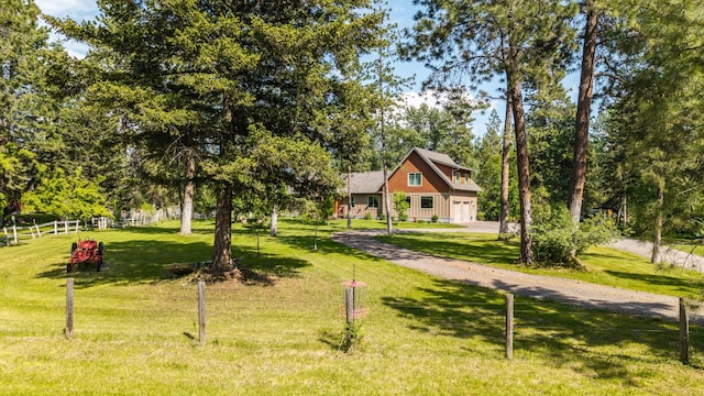 1265 Jellison Rd, Columbia Falls, MT 59912 - view of front of house featuring a garage and view of wooded area