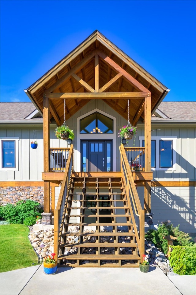 6659 Lamar Trl, Florence, MT 59833 - property entrance featuring board and batten siding, roof with shingles, and a porch