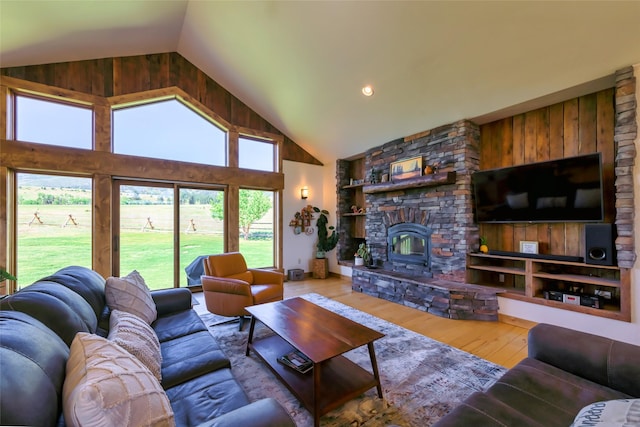 6659 Lamar Trl, Florence, MT 59833 - living area featuring hardwood / wood-style flooring, high vaulted ceiling, and a stone fireplace