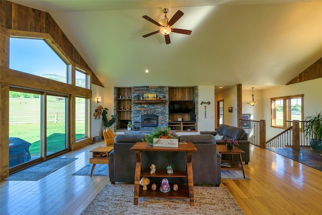 6659 Lamar Trl, Florence, MT 59833 - living area with high vaulted ceiling, a ceiling fan, hardwood / wood-style floors, a fireplace, and recessed lighting
