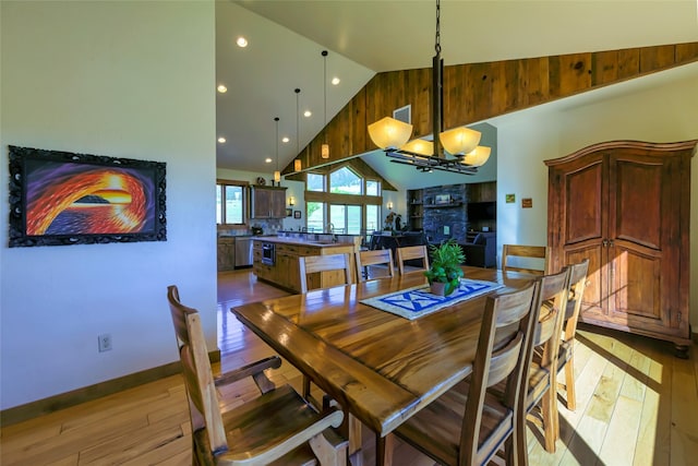 6659 Lamar Trl, Florence, MT 59833 - dining room featuring a chandelier, hardwood / wood-style floors, high vaulted ceiling, and recessed lighting