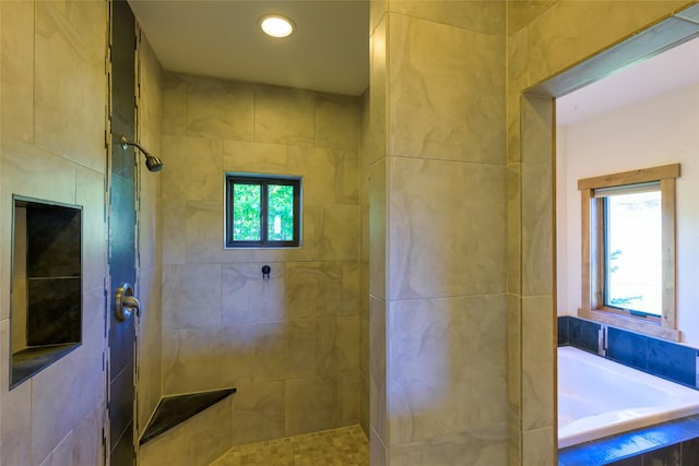 6659 Lamar Trl, Florence, MT 59833 - bathroom featuring a bath, a tile shower, and recessed lighting