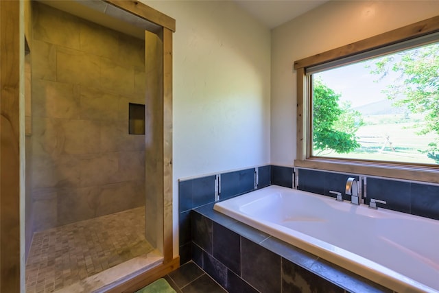 6659 Lamar Trl, Florence, MT 59833 - full bath featuring a bath, healthy amount of natural light, tiled shower, and tile patterned flooring