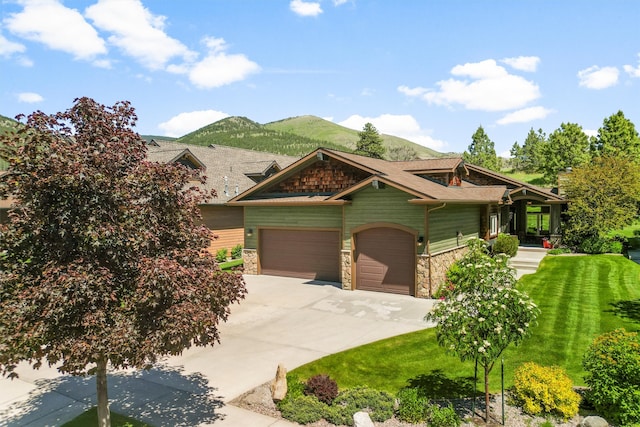720 Anglers Bend Way, Missoula, MT 59802 - craftsman-style house featuring stone siding, a garage, concrete driveway, a front lawn, and a mountain view