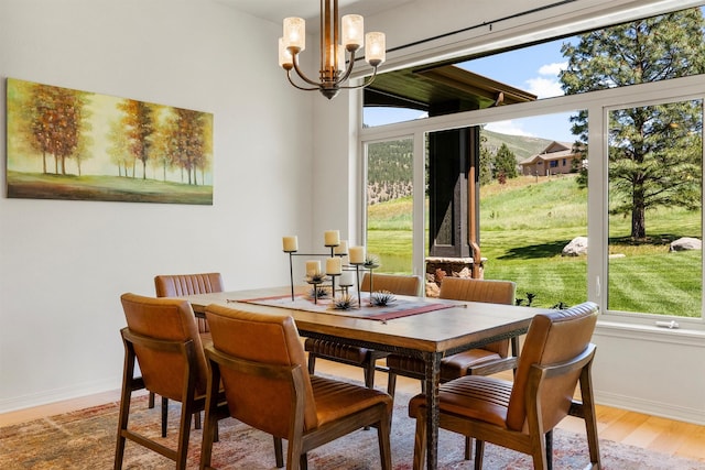 720 Anglers Bend Way, Missoula, MT 59802 - dining area with baseboards, a chandelier, and wood finished floors
