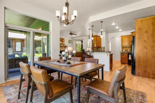 720 Anglers Bend Way, Missoula, MT 59802 - dining space with light wood-type flooring, a chandelier, arched walkways, a ceiling fan, and recessed lighting