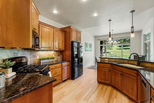720 Anglers Bend Way, Missoula, MT 59802 - kitchen with black appliances, a sink, light wood-style floors, decorative backsplash, and brown cabinets