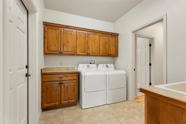 720 Anglers Bend Way, Missoula, MT 59802 - laundry room featuring cabinet space, washer and dryer, and light tile patterned floors