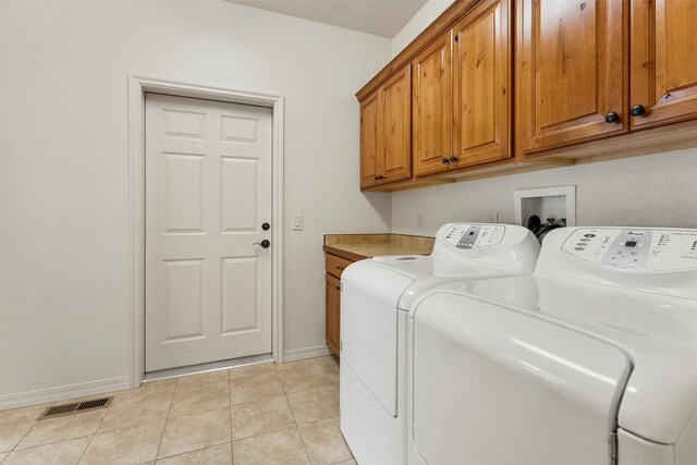720 Anglers Bend Way, Missoula, MT 59802 - washroom with washer and clothes dryer, cabinet space, baseboards, and light tile patterned flooring