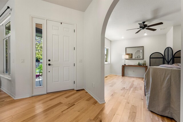 720 Anglers Bend Way, Missoula, MT 59802 - entryway featuring arched walkways, light wood-type flooring, ceiling fan, and baseboards
