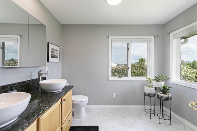10190 Kona Ranch Rd, Missoula, MT 59808 - bathroom with double vanity, toilet, and baseboards