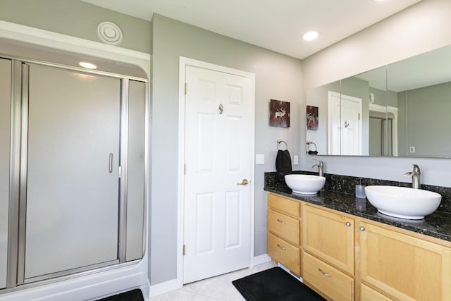 10190 Kona Ranch Rd, Missoula, MT 59808 - full bathroom featuring a shower stall, double vanity, tile patterned floors, baseboards, and recessed lighting