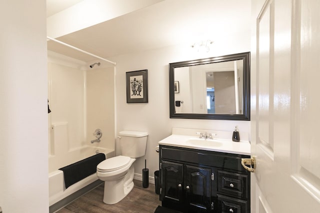 10190 Kona Ranch Rd, Missoula, MT 59808 - bathroom with toilet, vanity, washtub / shower combination, wood finished floors, and baseboards