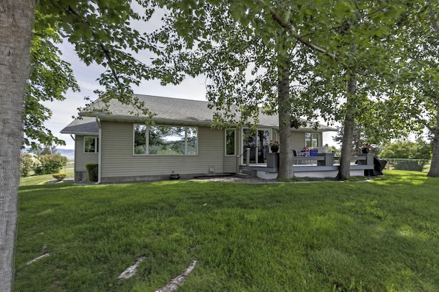 10190 Kona Ranch Rd, Missoula, MT 59808 - view of front facade featuring a front lawn, roof with shingles, and a wooden deck