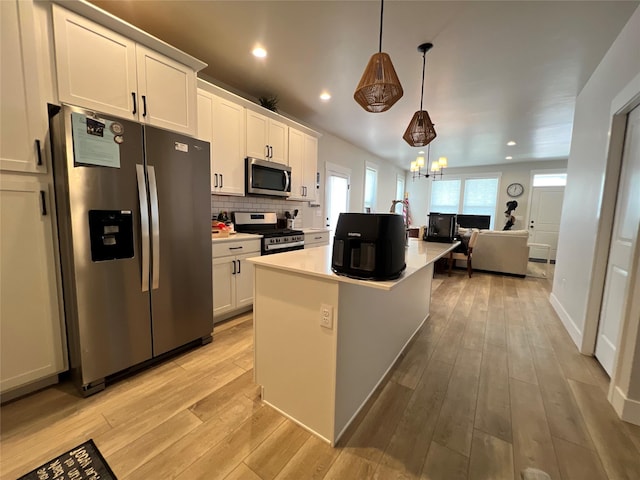 2883 Adam Run Ave, Helena, MT 59601 - kitchen with appliances with stainless steel finishes, light countertops, white cabinets, light wood-type flooring, and recessed lighting