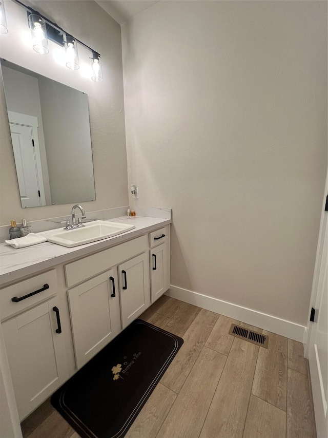 2883 Adam Run Ave, Helena, MT 59601 - bathroom with wood finished floors, vanity, and baseboards