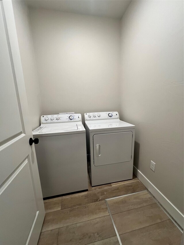 2883 Adam Run Ave, Helena, MT 59601 - washroom with washing machine and dryer, wood finished floors, and baseboards