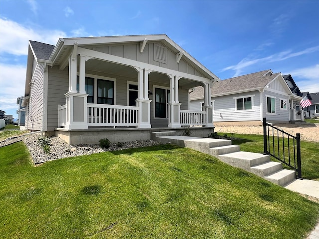 2883 Adam Run Ave, Helena, MT 59601 - view of front facade featuring covered porch, a front yard, and board and batten siding