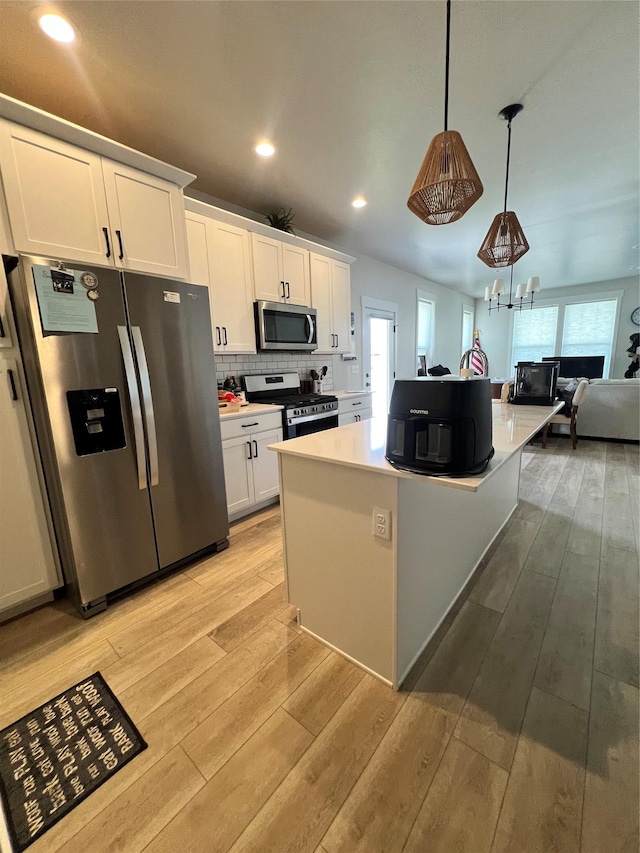 2883 Adam Run Ave, Helena, MT 59601 - kitchen featuring appliances with stainless steel finishes, healthy amount of natural light, light wood-style floors, and recessed lighting