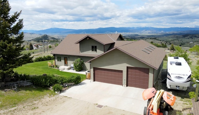 3380 Moulton Reservoir Rd, Butte, MT 59701 - view of front facade with a mountain view, driveway, and an attached garage