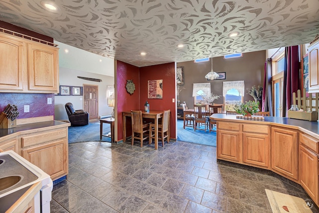 3380 Moulton Reservoir Rd, Butte, MT 59701 - kitchen featuring stove, recessed lighting, stone tile flooring, hanging light fixtures, and baseboards