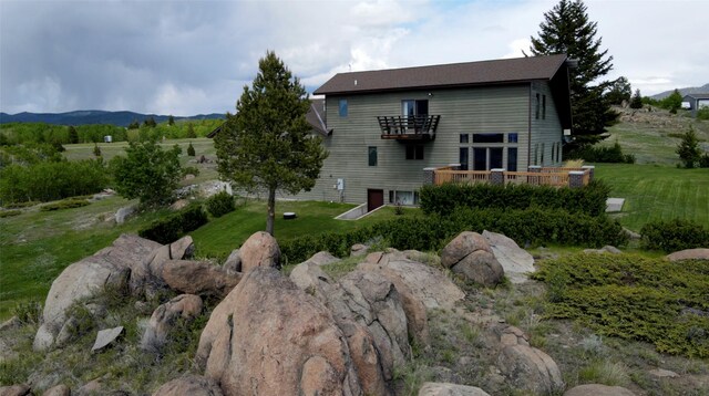 3380 Moulton Reservoir Rd, Butte, MT 59701 - back of house featuring a balcony, a lawn, and a wooden deck