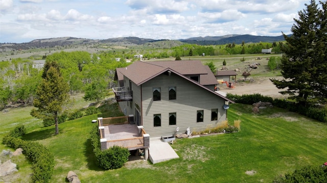 3380 Moulton Reservoir Rd, Butte, MT 59701 - back of house with a balcony, a lawn, and a deck with mountain view