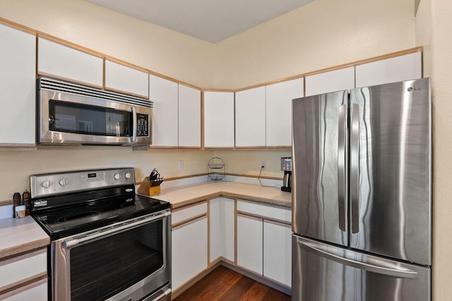 2249 Canvasback Ct, Kalispell, MT 59901 - kitchen featuring stainless steel appliances, light countertops, dark wood-style floors, and white cabinetry