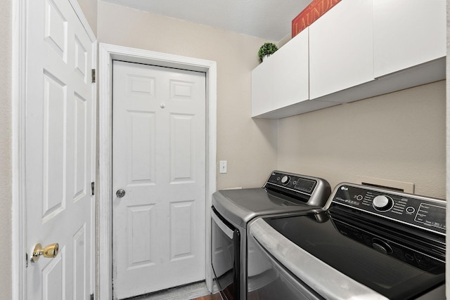 2249 Canvasback Ct, Kalispell, MT 59901 - washroom featuring separate washer and dryer and cabinet space