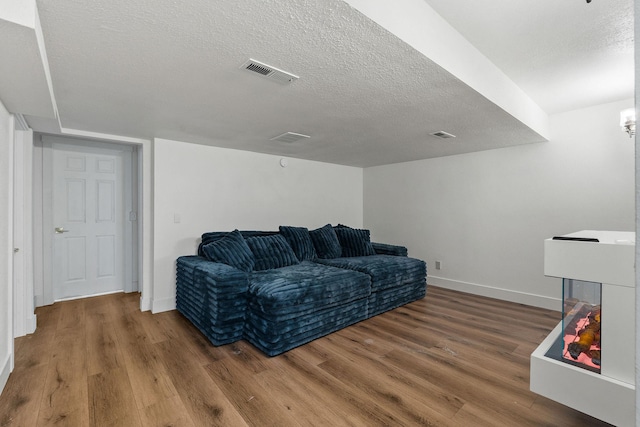 2249 Canvasback Ct, Kalispell, MT 59901 - sitting room featuring wood finished floors, a textured ceiling, and baseboards