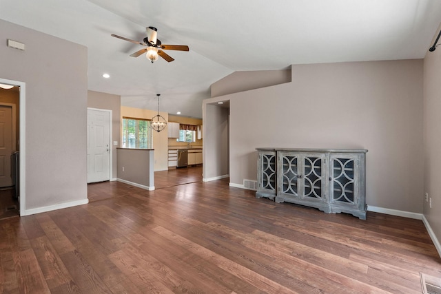 2249 Canvasback Ct, Kalispell, MT 59901 - unfurnished living room with ceiling fan, vaulted ceiling, wood finished floors, baseboards, and a chandelier