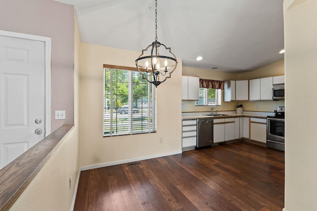 2249 Canvasback Ct, Kalispell, MT 59901 - kitchen featuring stainless steel appliances, white cabinets, a chandelier, dark wood finished floors, and baseboards