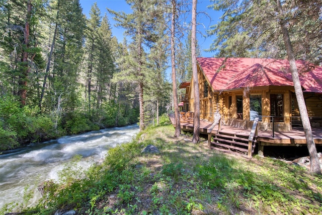 1062 Bear Creek Trl, Victor, MT 59875 - view of yard with a wooden deck and a view of trees