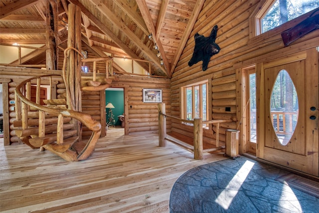 1062 Bear Creek Trl, Victor, MT 59875 - entrance foyer featuring high vaulted ceiling, a wooden ceiling with exposed beams, log walls, and hardwood / wood-style flooring