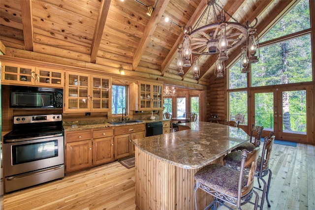1062 Bear Creek Trl, Victor, MT 59875 - kitchen with black appliances, french doors, a wooden ceiling with exposed beams, light wood finished floors, and rustic walls